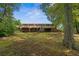 Expansive backyard featuring a deck and mature trees, providing privacy and shade at 6674 Cowan Mill Rd, Winston, GA 30187