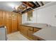 Basement kitchenette features wood cabinets, a double sink, gas range, and linoleum flooring at 6674 Cowan Mill Rd, Winston, GA 30187