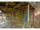 Brick basement featuring multiple doors and a concrete deck with a wood ceiling at 6674 Cowan Mill Rd, Winston, GA 30187