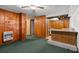 Partially finished basement with wood paneling, green carpet, built-in cabinets, and an electric heater at 6674 Cowan Mill Rd, Winston, GA 30187