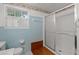 Bright bathroom showcasing blue tile accents and a glass-enclosed shower for a fresh and clean feel at 6674 Cowan Mill Rd, Winston, GA 30187