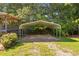 Metal carport on a green lawn with trees in the background at 6674 Cowan Mill Rd, Winston, GA 30187
