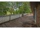 Long, partially-covered deck overlooks a yard with mature trees at 6674 Cowan Mill Rd, Winston, GA 30187