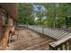 Large wooden deck with white railing overlooks a treed backyard at 6674 Cowan Mill Rd, Winston, GA 30187