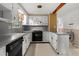 Traditional kitchen features white cabinets, tile flooring, and modern appliances for efficient cooking at 6674 Cowan Mill Rd, Winston, GA 30187