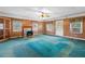 Spacious living room features wood paneling, a ceiling fan, and a decorative fireplace for a cozy atmosphere at 6674 Cowan Mill Rd, Winston, GA 30187