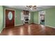 The living room offers hardwood floors, a fireplace, and natural light from large windows at 6674 Cowan Mill Rd, Winston, GA 30187