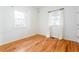 Bright bedroom featuring hardwood floors and white walls, complemented by windows and light curtains at 83 Ormond Se St, Atlanta, GA 30315