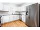 Modern kitchen with white cabinets, stainless steel appliances, and dark countertops at 83 Ormond Se St, Atlanta, GA 30315