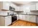 Updated kitchen featuring white cabinets, granite countertops, stainless steel appliances and hardwood floors at 83 Ormond Se St, Atlanta, GA 30315