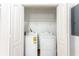 Convenient laundry area with washer, dryer and shelving for storage at 83 Ormond Se St, Atlanta, GA 30315