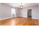 Bright living room with beautiful hardwood floors and modern lighting fixture, fresh paint, and trim at 83 Ormond Se St, Atlanta, GA 30315