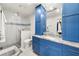 Bright bathroom features a glass shower, granite counters, and custom blue vanity for a modern look at 2110 Augusta Se Dr # 204, Marietta, GA 30067