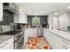 Modern kitchen features sleek white cabinetry, stainless steel appliances, and stylish tile backsplash at 2110 Augusta Se Dr # 204, Marietta, GA 30067