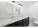 Bathroom featuring double sinks, dark cabinets, a toilet, and stylish mirrors at 383 Ralph Mcgill Ne Blvd # J, Atlanta, GA 30312