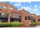 Exterior of brick townhomes with balconies, manicured hedges, and blue sky at 383 Ralph Mcgill Ne Blvd # J, Atlanta, GA 30312