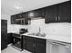 Updated kitchen featuring stainless steel appliances, black cabinets, and white countertops at 383 Ralph Mcgill Ne Blvd # J, Atlanta, GA 30312