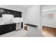 Kitchen with stainless steel appliances, black cabinets, and breakfast bar at 383 Ralph Mcgill Ne Blvd # J, Atlanta, GA 30312