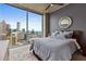 Bedroom with a modern aesthetic and a stunning city view from the expansive windows at 400 W Peachtree Nw St # 3711, Atlanta, GA 30308