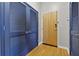 Condo entryway featuring hardwood floors, a wooden front door and closet with blue louvered doors at 400 W Peachtree Nw St # 3711, Atlanta, GA 30308