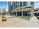 Building exterior featuring storefront retail space at the bottom of a high-rise residential building at 400 W Peachtree Nw St # 3711, Atlanta, GA 30308