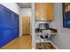 Hallway showing a built-in desk, wooden floors, with closet and wooden front door at 400 W Peachtree Nw St # 3711, Atlanta, GA 30308