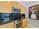 Updated kitchen with stainless steel appliances, black backsplash, and light wood cabinets at 400 W Peachtree Nw St # 3711, Atlanta, GA 30308