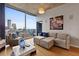 Bright living room featuring comfortable seating and city views from floor-to-ceiling windows at 400 W Peachtree Nw St # 3711, Atlanta, GA 30308