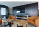 Resident lounge area with comfortable seating centered around a fireplace and large screen TV at 400 W Peachtree Nw St # 3711, Atlanta, GA 30308