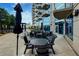 Outdoor patio space featuring a community seating area and umbrellas for shade at 400 W Peachtree Nw St # 3711, Atlanta, GA 30308