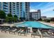 Outdoor swimming pool area featuring lounge chairs and a large pool with a skyline view at 400 W Peachtree Nw St # 3711, Atlanta, GA 30308