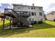 Two-story home featuring backyard with deck, staircase, and well-maintained lawn at 199 Scenic View Ln, Stone Mountain, GA 30087