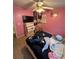 Bedroom with a ceiling fan, bed, television, and posters on the walls at 199 Scenic View Ln, Stone Mountain, GA 30087