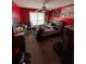 A bright bedroom with red walls and a ceiling fan above a full-sized bed at 199 Scenic View Ln, Stone Mountain, GA 30087