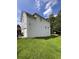 Side view of a home with green grass and partial view of garage at 199 Scenic View Ln, Stone Mountain, GA 30087
