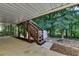 The backyard features a shed with access via stairs from a covered patio and a wooded lot at 1990 Holly Cove Rd, Cumming, GA 30040