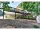 The backyard is partially covered with a deck featuring stairs, storage, and a shed at 1990 Holly Cove Rd, Cumming, GA 30040