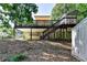 A partially covered deck overlooks the backyard with a shed and wooded perimeter at 1990 Holly Cove Rd, Cumming, GA 30040