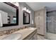 Well-lit bathroom featuring a double vanity, granite countertops, and a glass-enclosed shower at 1990 Holly Cove Rd, Cumming, GA 30040