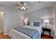 Bright bedroom featuring hardwood floors, a ceiling fan, and night stands with lamps at 1990 Holly Cove Rd, Cumming, GA 30040