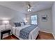 Bright bedroom featuring hardwood floors, a ceiling fan, and a window with natural light at 1990 Holly Cove Rd, Cumming, GA 30040