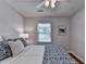 Bright bedroom featuring hardwood floors, a ceiling fan, and a window with natural light at 1990 Holly Cove Rd, Cumming, GA 30040