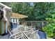 A spacious deck has ample seating and a retractable awning for flexible outdoor living at 1990 Holly Cove Rd, Cumming, GA 30040