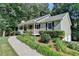 Charming home with covered front porch, beautiful flower beds, and lush landscaping at 1990 Holly Cove Rd, Cumming, GA 30040