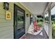 Front porch view, featuring a comfortable rocking chair and a warm welcome at 1990 Holly Cove Rd, Cumming, GA 30040