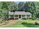 Inviting home with a covered porch, manicured bushes and beautiful lawn at 1990 Holly Cove Rd, Cumming, GA 30040