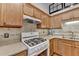 Bright kitchen featuring wood cabinets, stone countertops, and stainless-steel appliances at 1990 Holly Cove Rd, Cumming, GA 30040