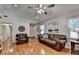 Comfortable living room with hardwood floors, leather sofa, and view to entry way at 1990 Holly Cove Rd, Cumming, GA 30040