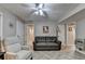 Cozy living room features tile flooring and neutral paint colors with a ceiling fan for added comfort at 1990 Holly Cove Rd, Cumming, GA 30040