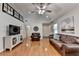 Open-concept living room with vaulted ceiling, hardwood floors, and television at 1990 Holly Cove Rd, Cumming, GA 30040